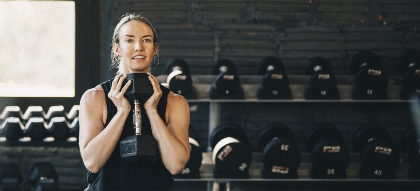 Woman doing sit-ups with small weight
