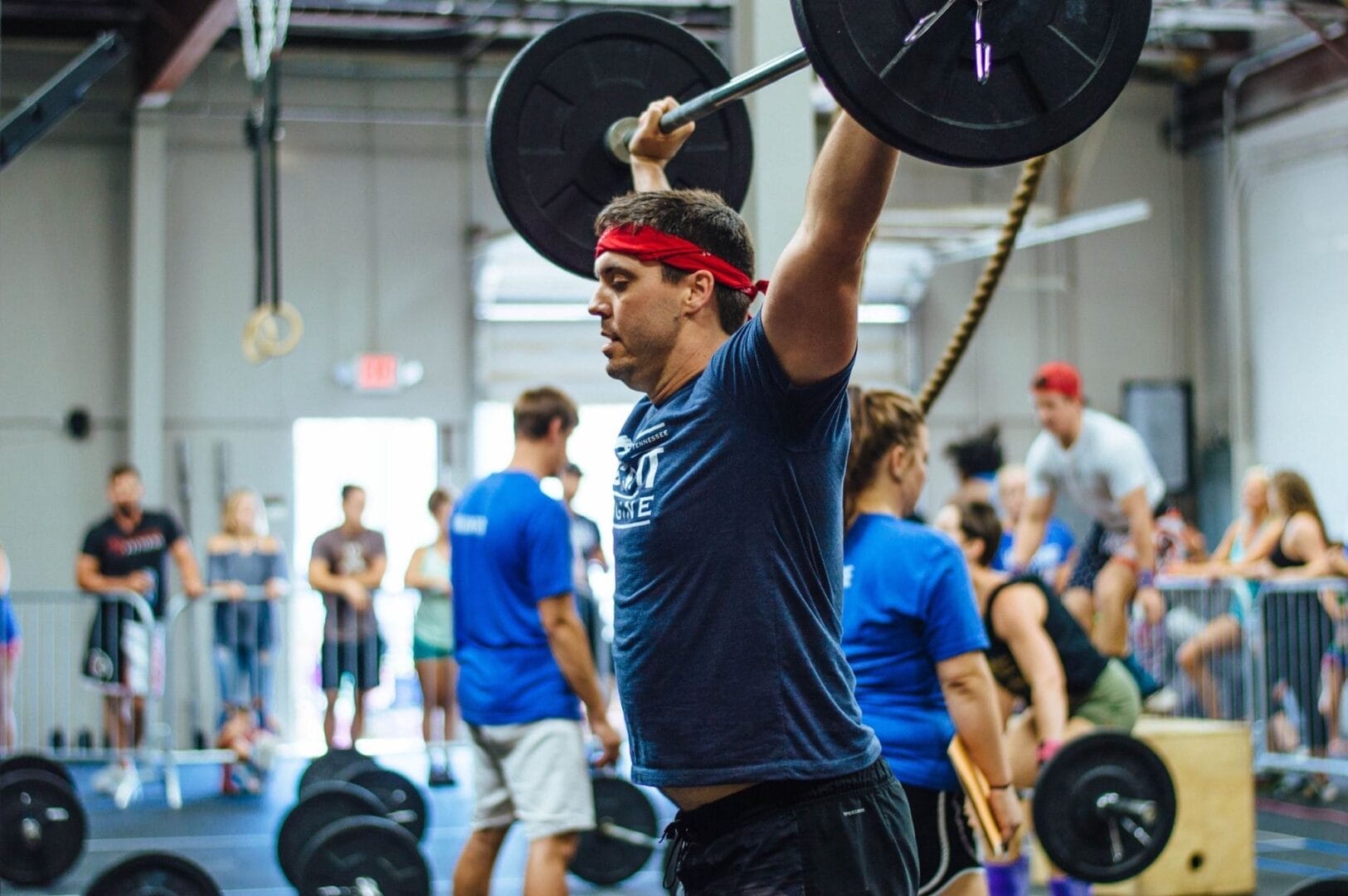 Man lifting weights overhead